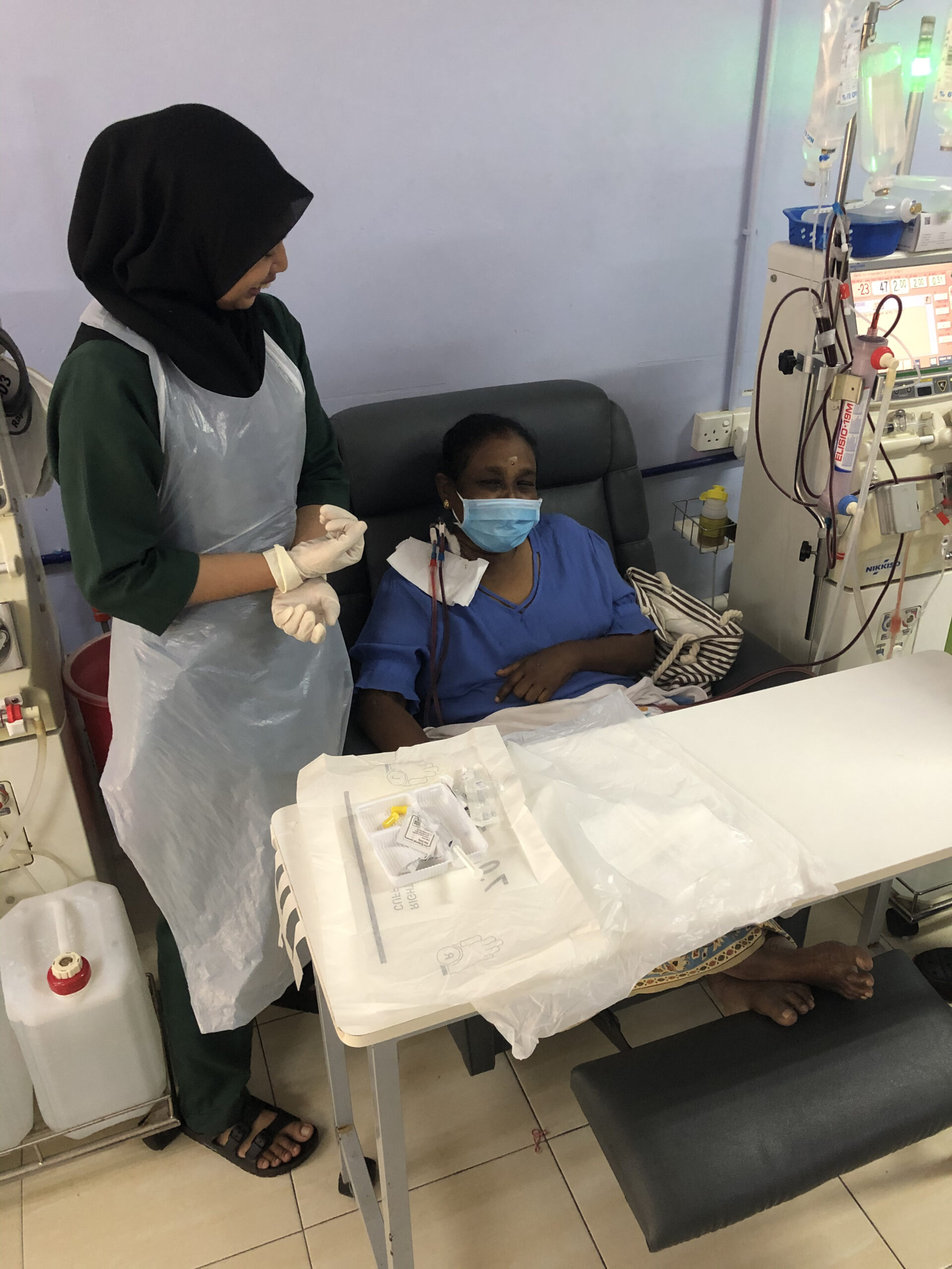 Nurse talking beside patient at Pusat Hemodialisis Nur Ain