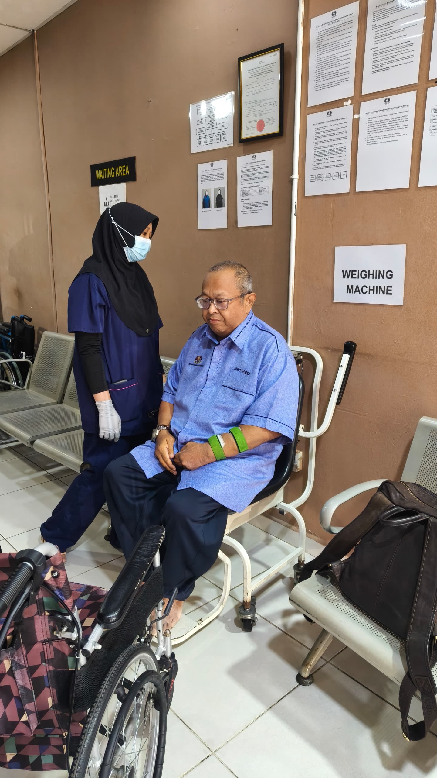 Nurse assisting patient taking body weight at Pusat Hemodialisis Nur Ain